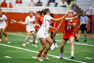 An SU defender closely guards Cornell's Kristy Gilbert. 