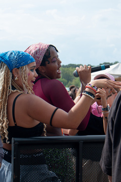 Sophia Herrera and Nyobi Boddie sing with Doechii during the opening set of University Union’s 2022 Juice Jam. The two students brought energy to the audience as they spit out lyrics to Doechii’s song “Spookie Coochie.” 