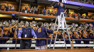 Justin Mertz (bottom left) stands in front of the Syracuse University Marching Band during the first home football game again Villanova on Saturday. Mertz, an SU alumnus and former member of the marching band, is going into his tenth year as director of SUMB and works with three drum majors and 34 section leaders.