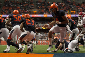 Syracuse running back Prince-Tyson Gulley looks to attack the N.C. State defense after taking a handoff from quarterback AJ Long.