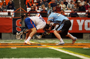 Syracuse faceoff specialist Danny Varello wins a draw against Johns Hopkins. 