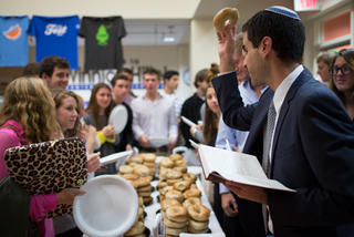 Rabbi Andrew Trief says a prayer over the food before everyone begins to eat.