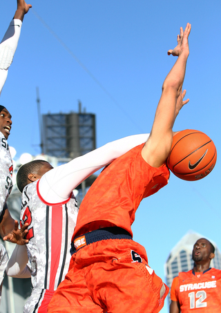 Players fight for posession during the game between the Syracuse Orange and the San Diego State Aztecs during the Battle on the Midway game on Sunday.