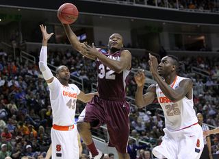 Kareem Jamar lofts the ball up to the basket against James Southerland and Rakeem Christmas.