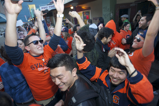 Syracuse University students celebrate outside of Chuck's Cafe.