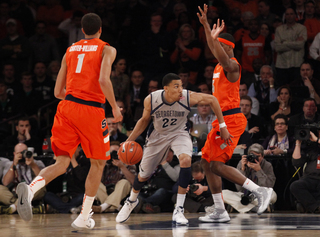 Georgetown's Otto Porter (#22) drives his way into the paint past C.J. Fair.