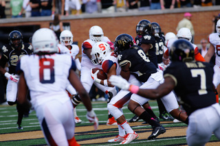 Steve Ishmael looks on as a Syracuse player is brought down. 