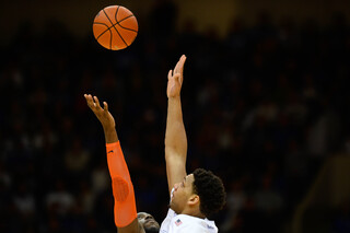 Okafor and SU's Rakeem Christmas jump for the opening tip.