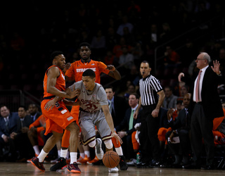 Patterson and fellow sophomore B.J. Johnson defend Hanlan, who tries to get past Patterson and get to the top of the key.