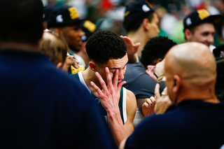 Forbes wipes his eyes as he tears up in a post-game interview at the center of the court. 