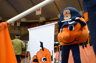 Otto, with Kurkjian inside the suit, prepares for the running of the flags with the male cheerleaders. 