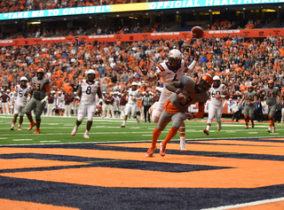 The football flies over a Virginia Tech defensive back and Ervin Philips in the end zone. Philips may not have scored on the pass, but he did find the end zone later. 