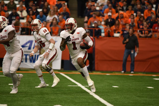 Samuels carries the ball looking for space around the edge.