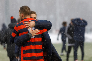 Ricks and Len Zeugner embrace after the game.