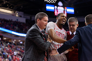 An Ohio State player is tended to by trainers after suffering a shoulder injury.