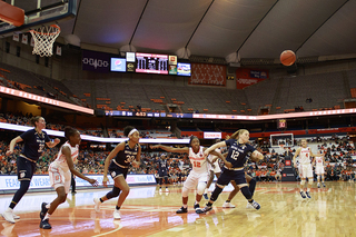 Syracuse and Notre Dame players scramble for a loose ball.