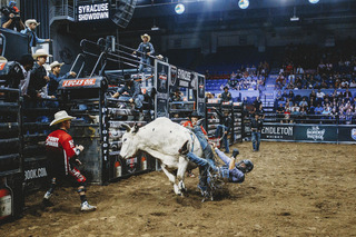 As his bull veers to the right, Joe Hostetler slips off the left side onto his back.