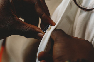 Mamoudou Camara helps place one of the Remembrance pins onto Gaelyn Smith's lapel.