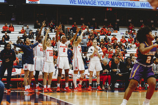 The Orange bench celebrates a basket.