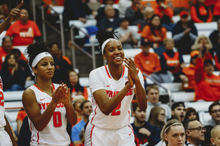 Two Syracuse players clap and cheer from the bench.