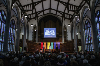 More than one hundred protesters gather within the United Methodist Church after marching through the snow from the James M. Hanley Federal Building. 