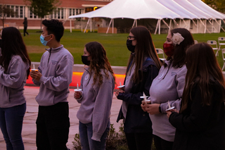 Remembrance Scholars line up to light their candles.