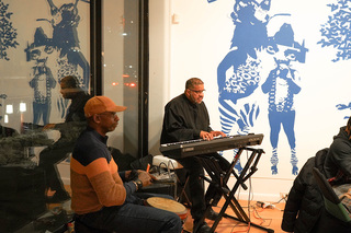 Artists play music in the lobby before the show begins.