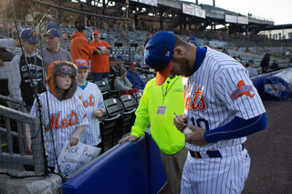 Patrick Mazeika signs baseballs for fans before the game. 