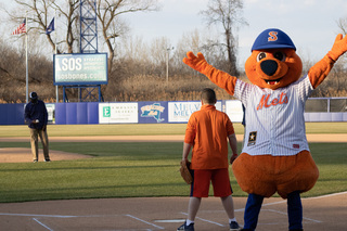 Scooch, the Syracuse Mets mascot, gets ready to umpire the first pitch of the game. 