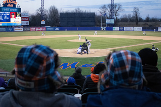 Fans watch the game as the sun sets on NBT Stadium. 