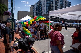 A group of friends pose in front of a Syracuse Juneteenth backdrop during the celebrations at City Hall, June 17th, 2022.